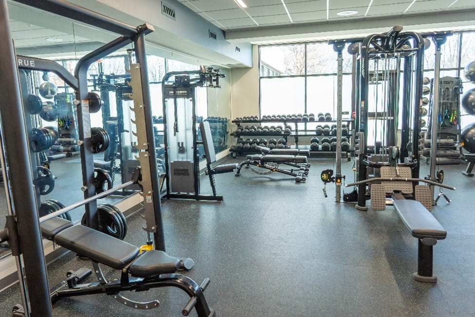 A fitness center with weight lifting equipment.