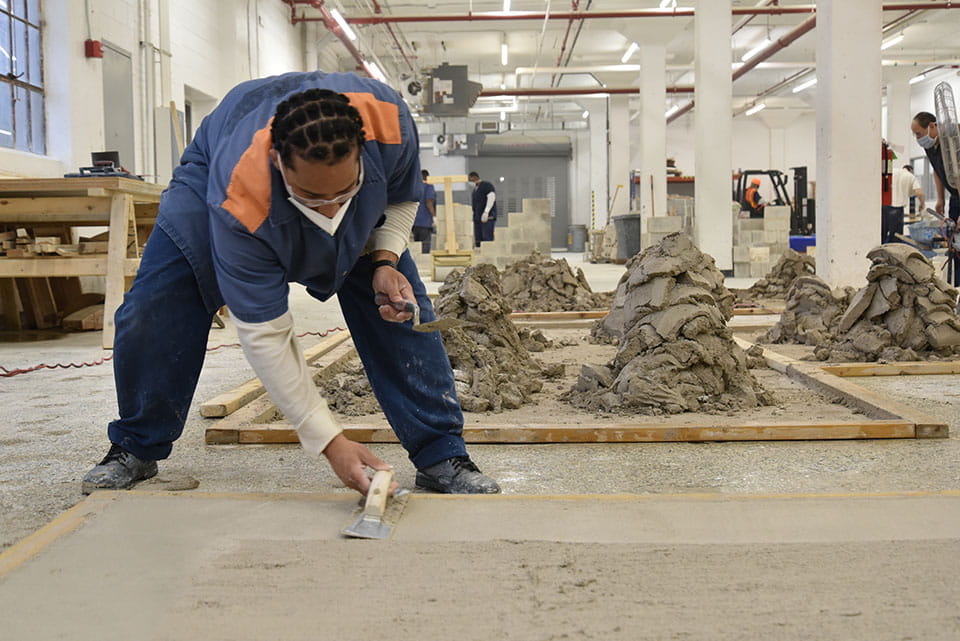 Photo of prisoner leveling concrete