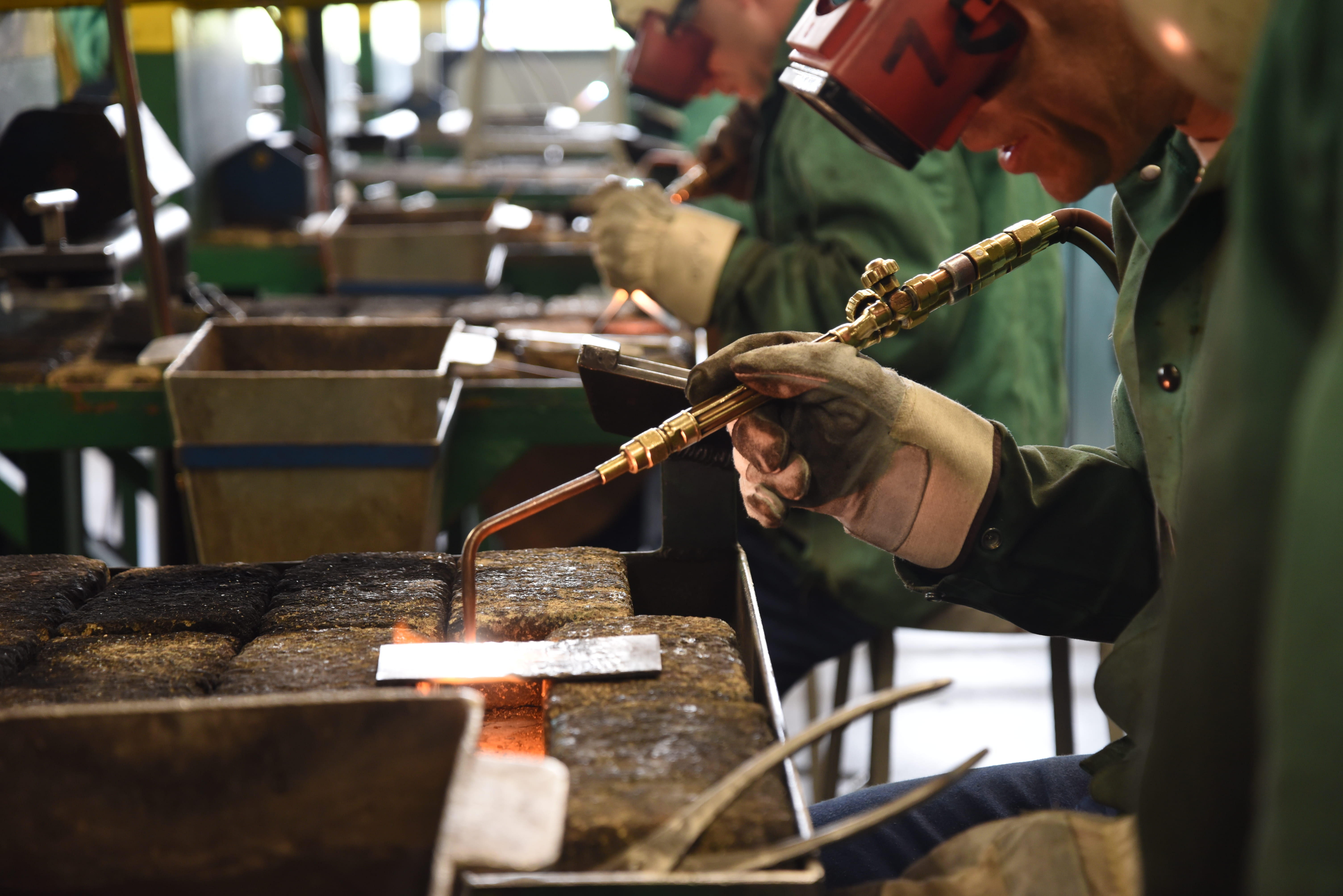 Photo of prisoners using welding equipment.
