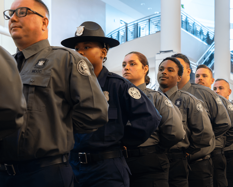 Corrections officers waiting to enter the main room of an event space.