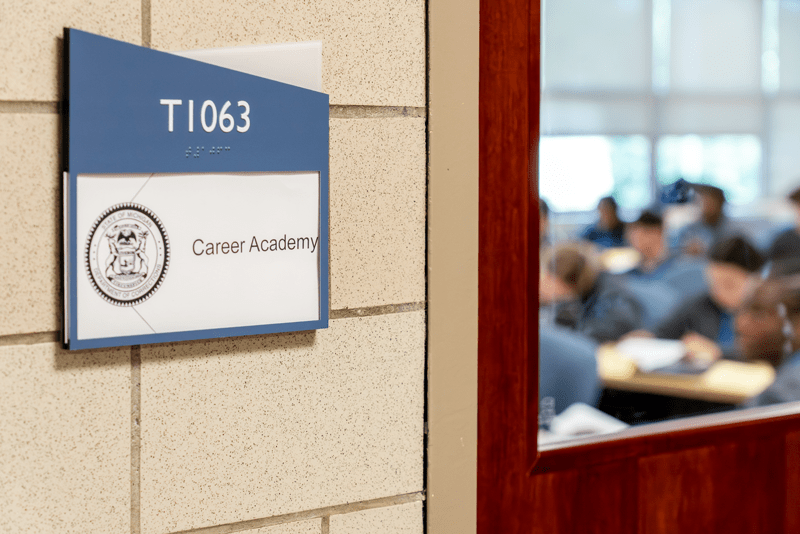 A sign mounted on a wall that reads "Career Academy."