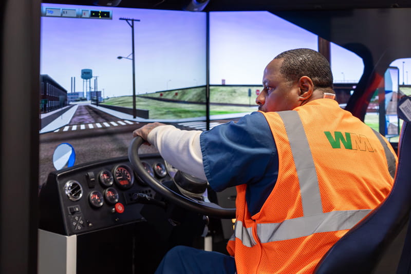 A male prisoner learning how to drive a commercial vehicle through a computer simulation.