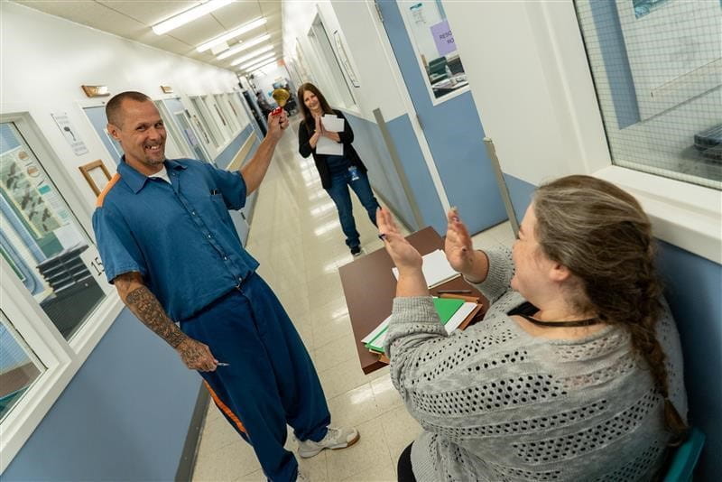 Road to Restoration attendee is reinstated with driver's license and rings bell in celebration