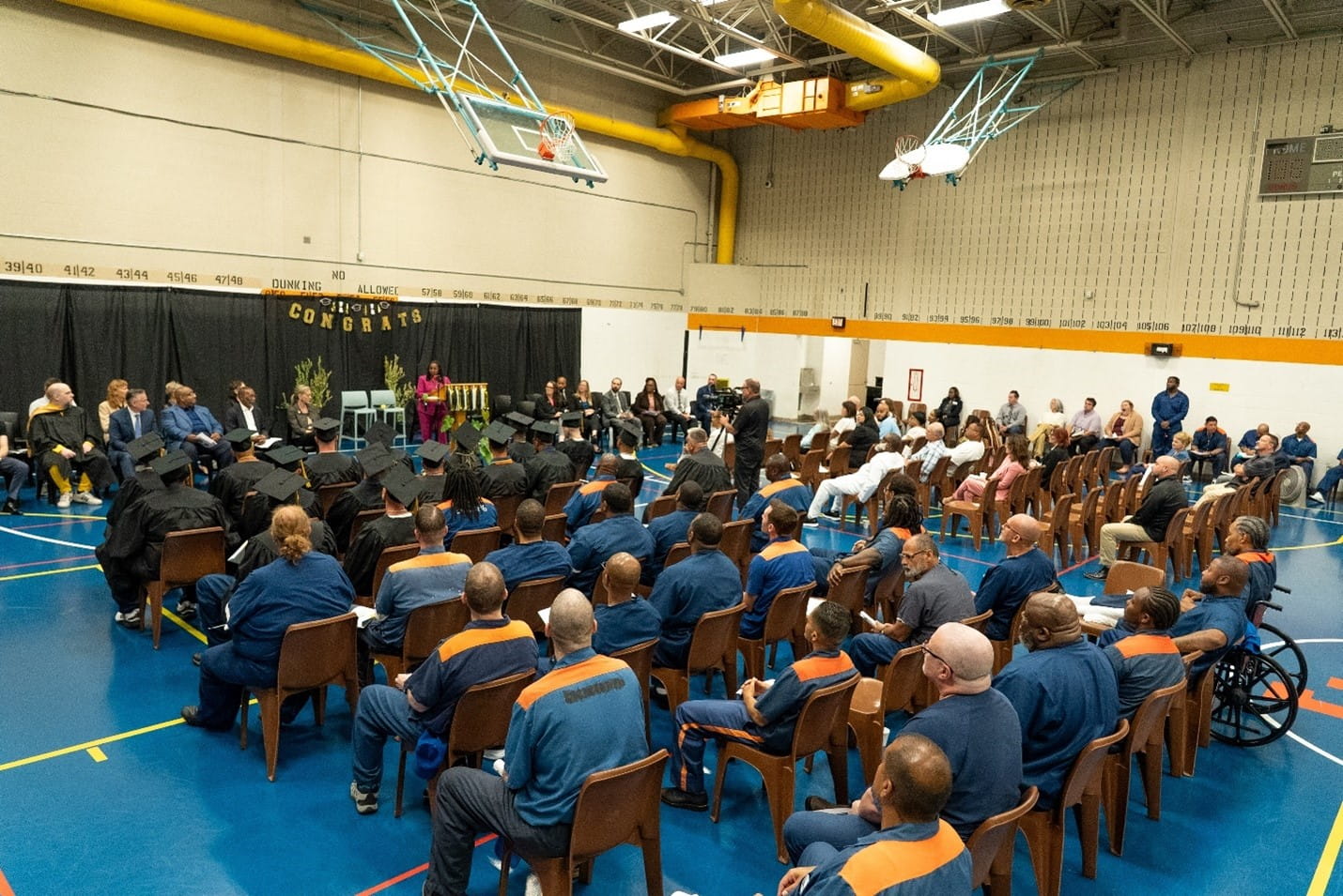Graduation for prisoners inside of a prison gymnasium