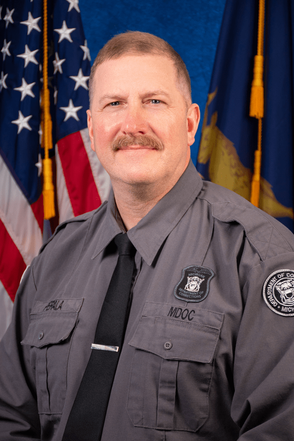 Corrections Officer Joseph Perala wearing his officer uniform.