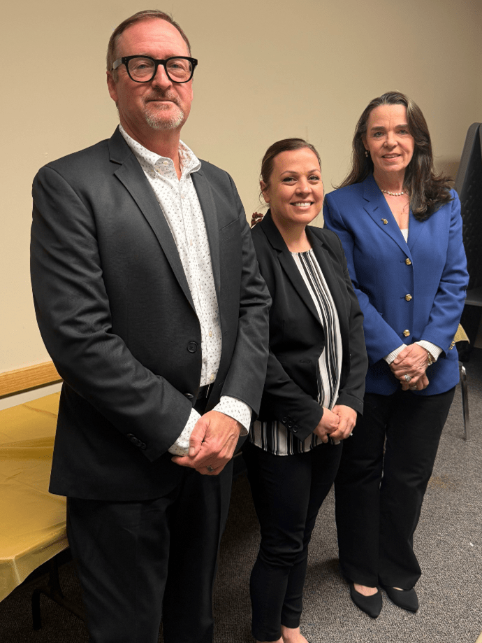 Deputy Director Russ Marlan, Agent of the Year Mickaela McKellar, and Director Heidi Washington