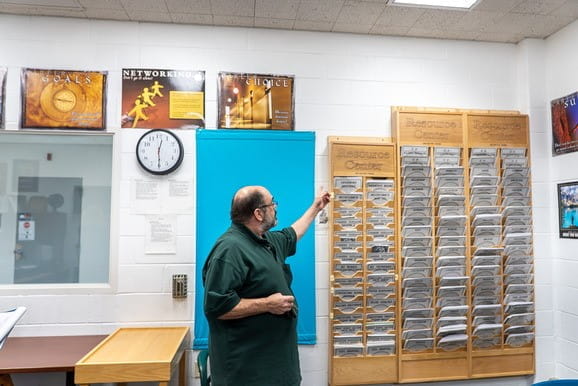 Employment Counselor Christopher Dean shows county-specific resources in his office at Bellamy Creek Correctional Facility.