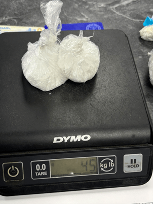 Recovered white powder in plastic bags on a scale