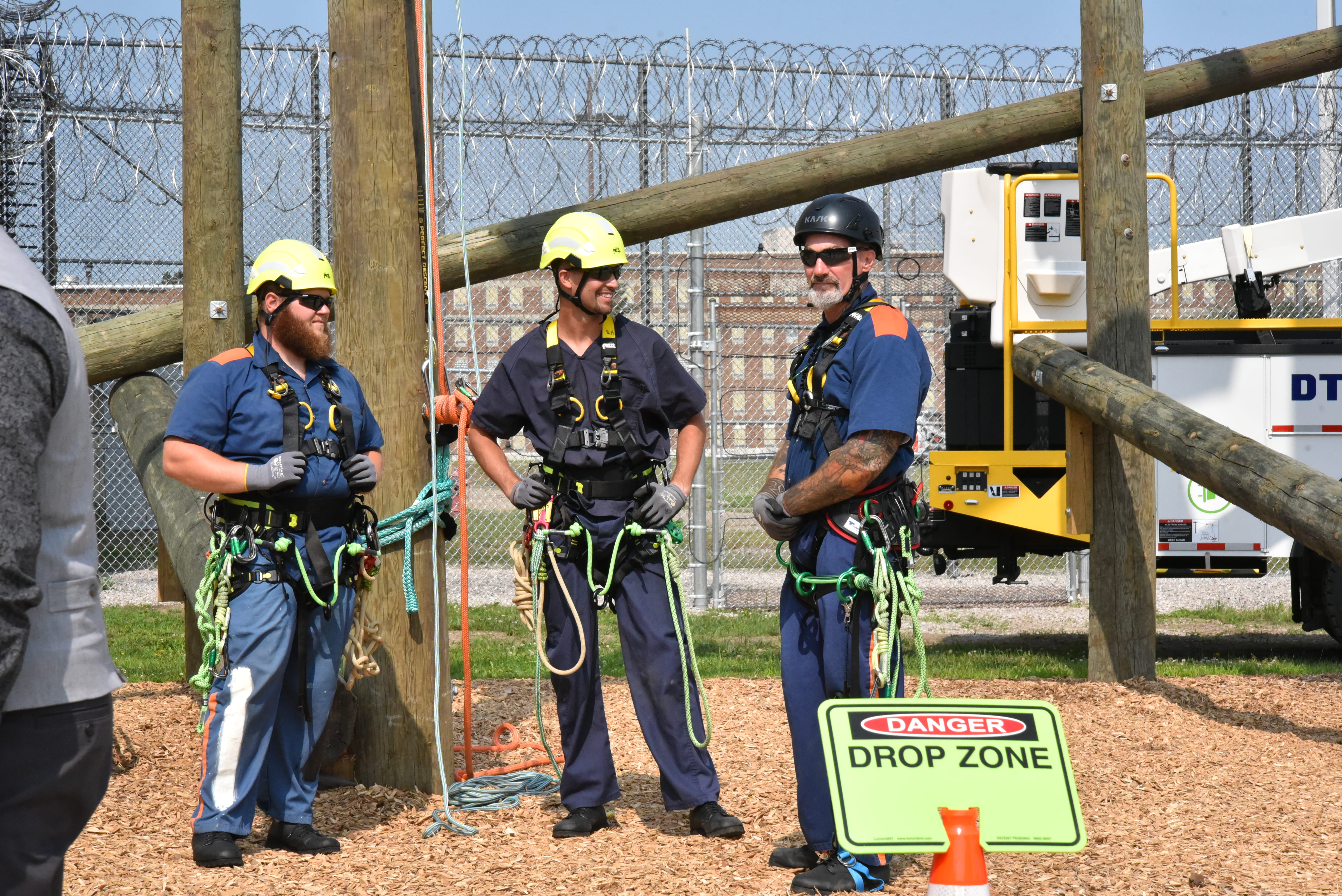 Photo of prisoners in tree trimming and climbing gear.
