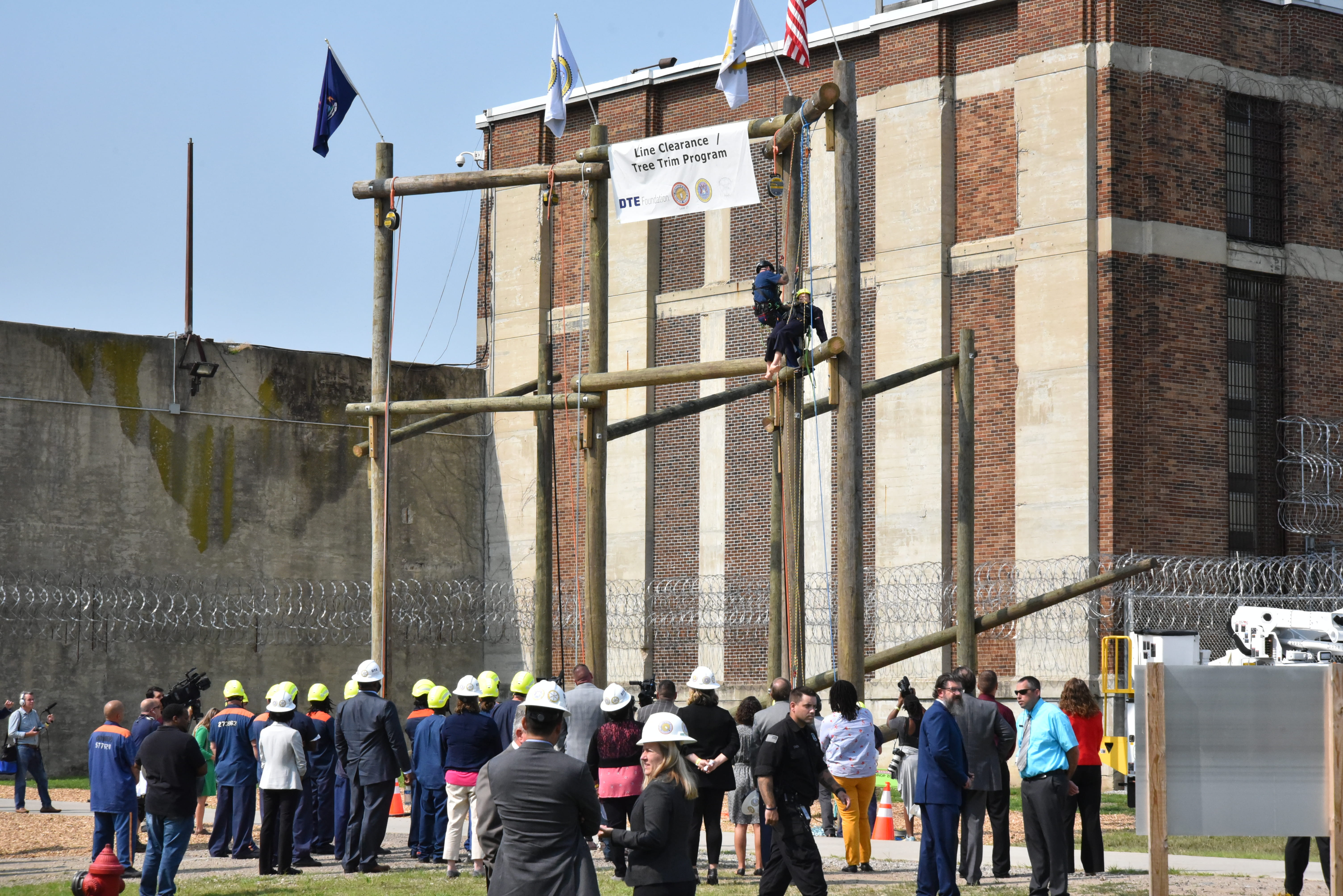 Photo of prisoners learning to climb poles.