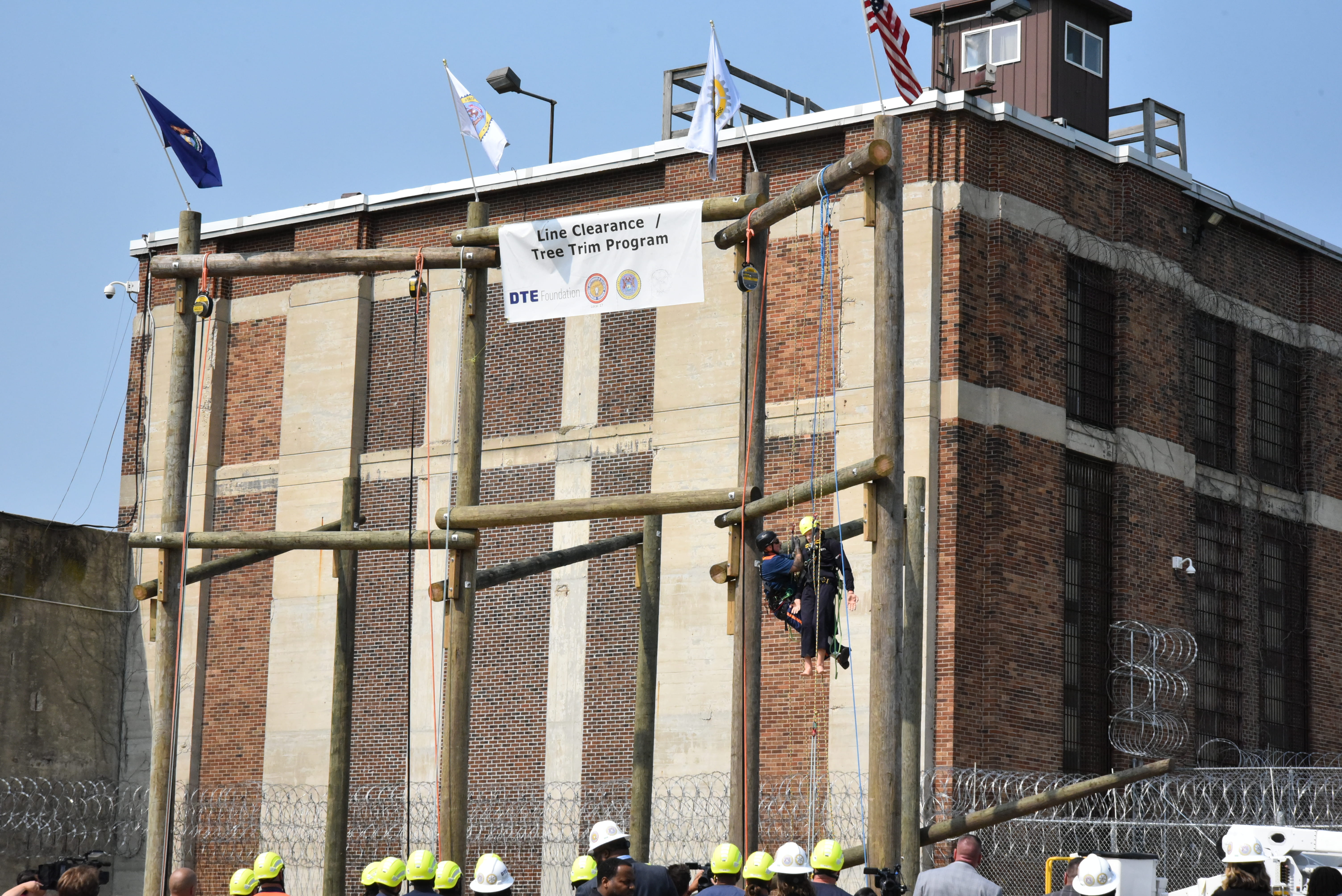 Photo of prisoners learning to climb poles.