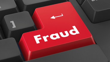 Red fraud button on a keyboard