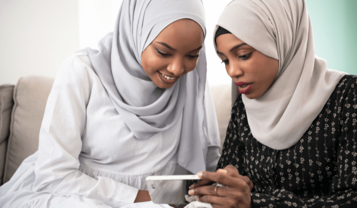 Two women looking at cell phone
