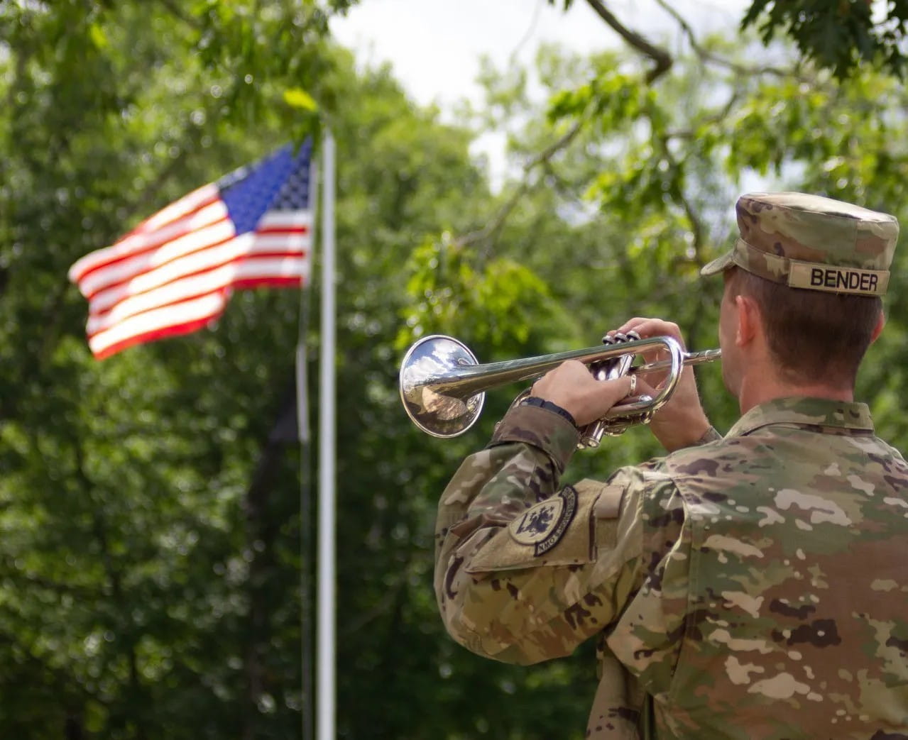 bugler staring at american flag