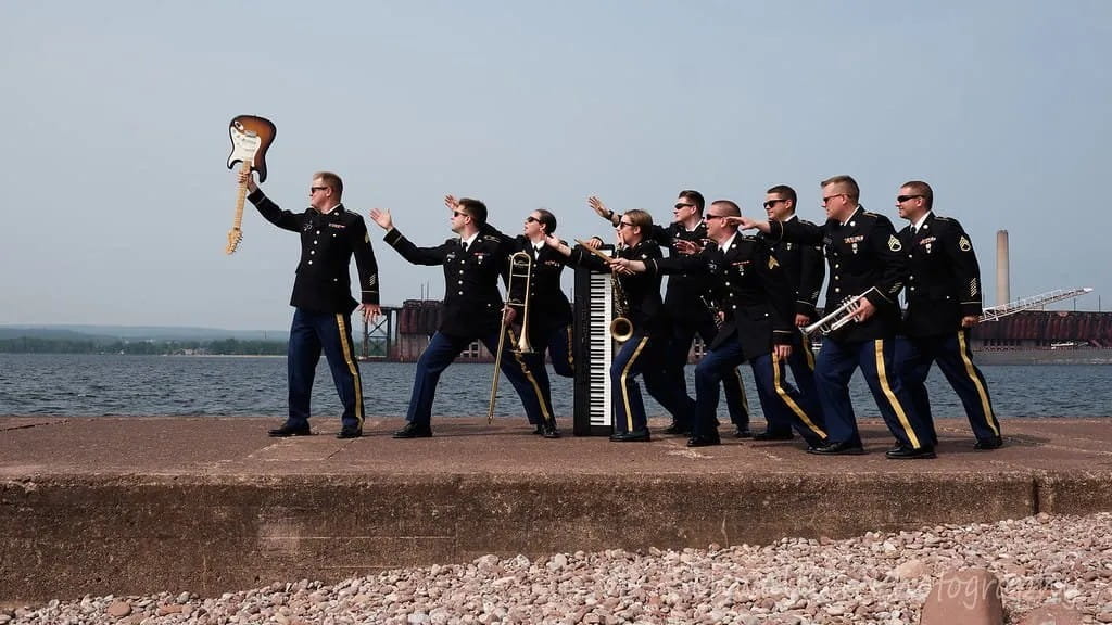 soldiers in rock band standing near shore line