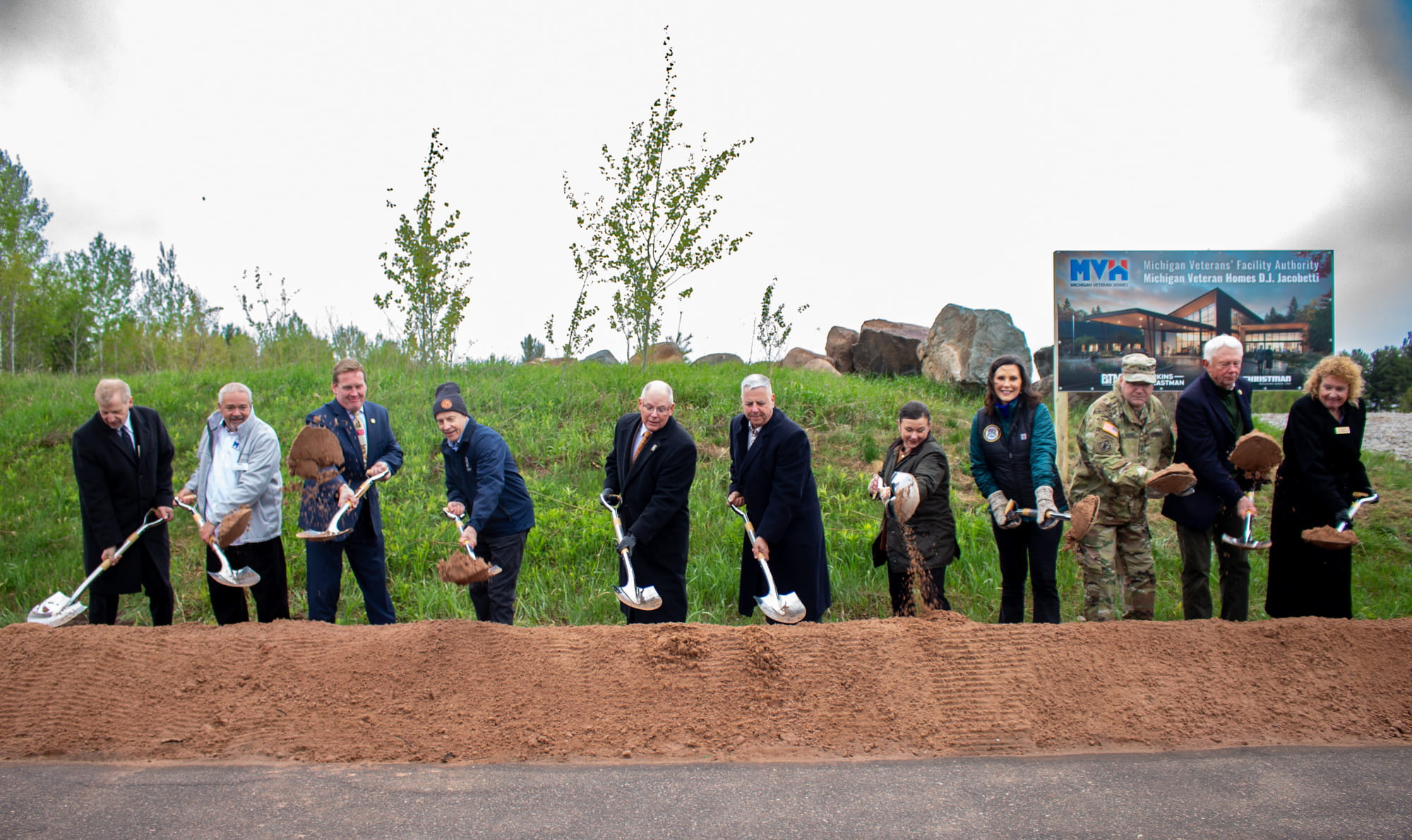 legislators shovel dirt at groundbreaking ceremony