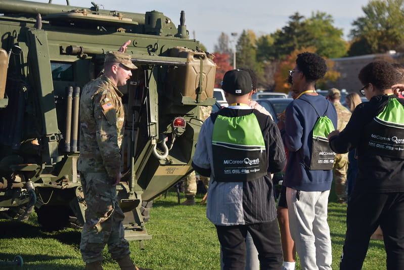 army Humvee with citizens looking at it 