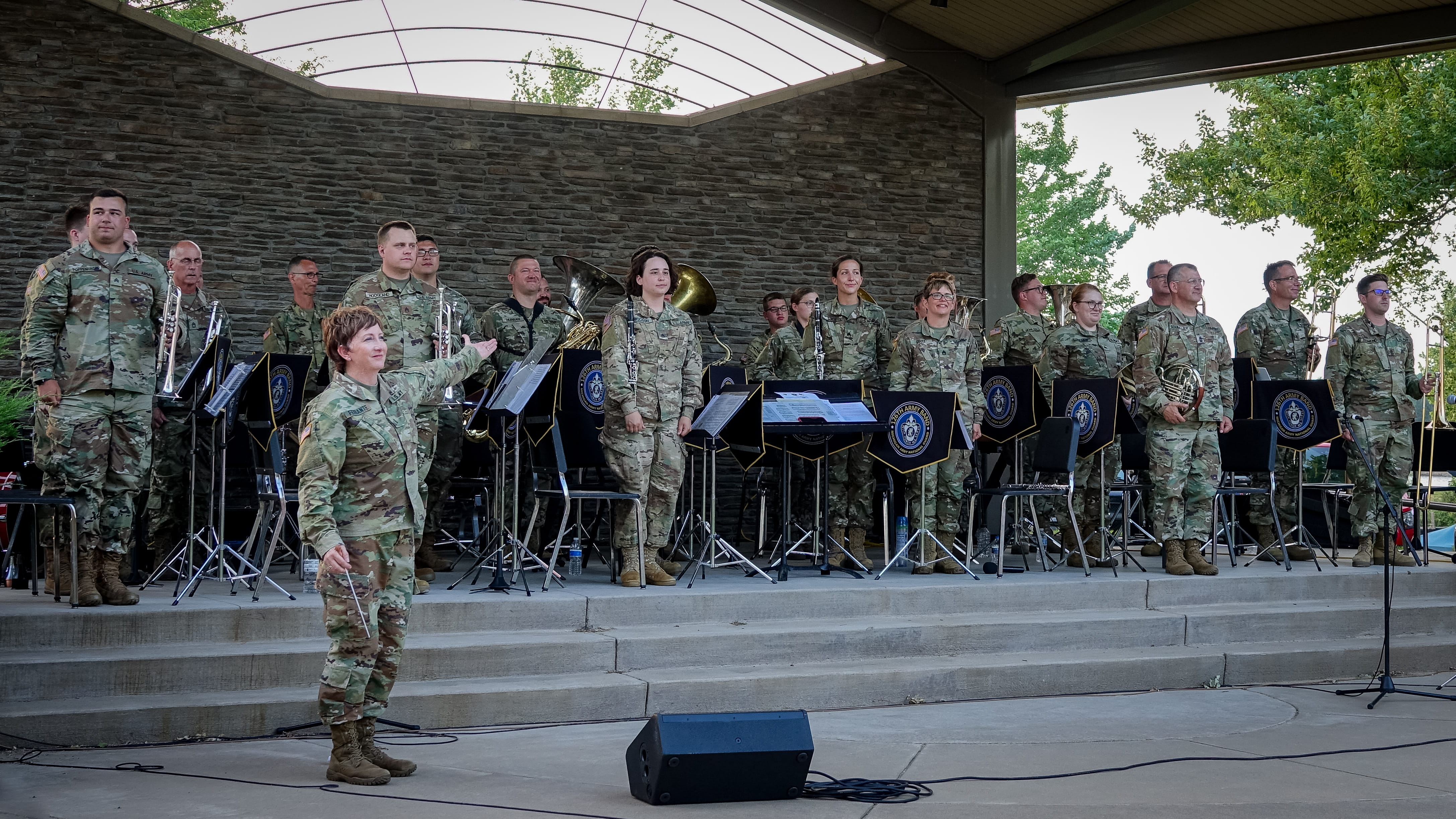 service members on stage performing music