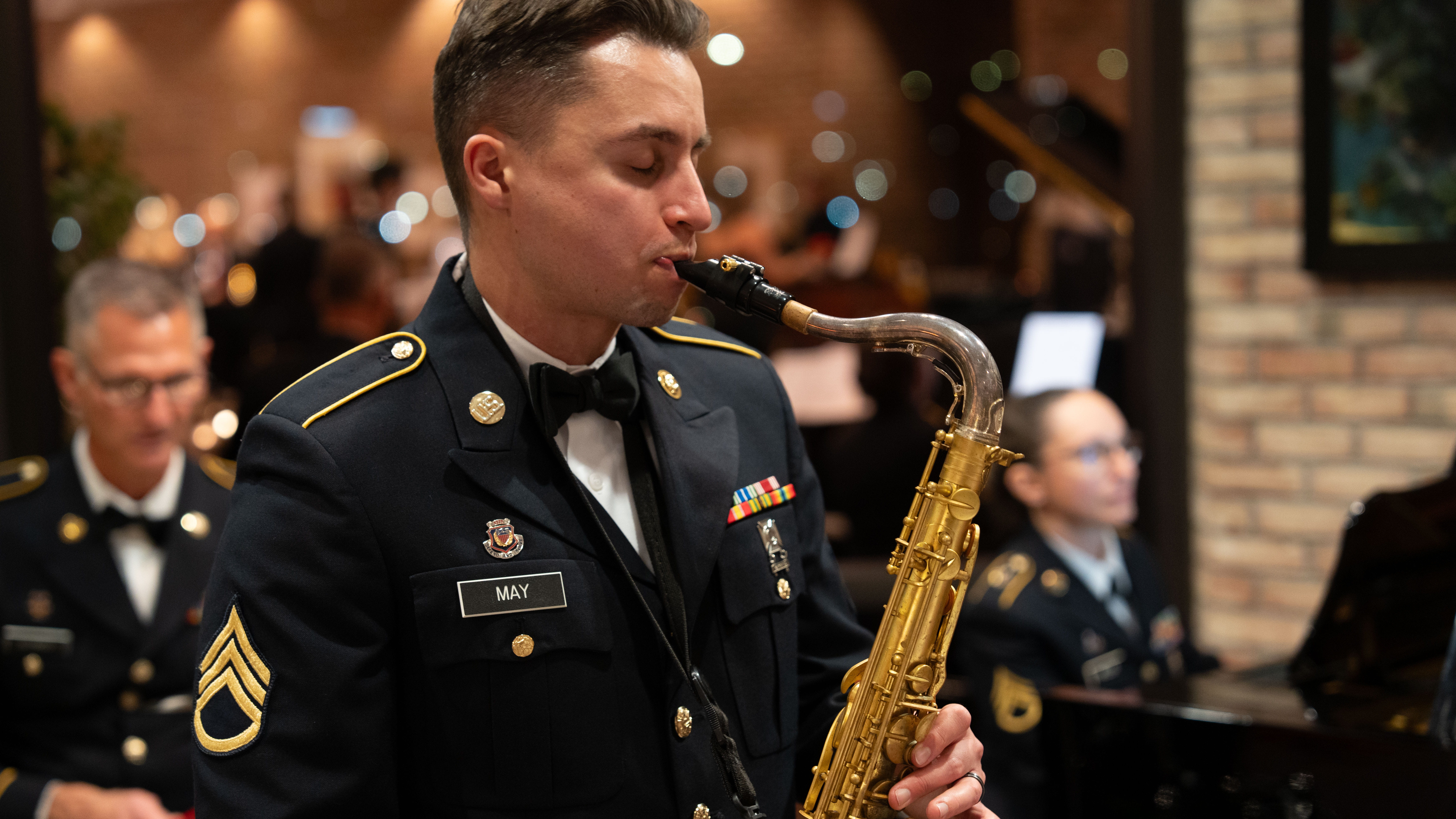 man in uniform playing horn instrument