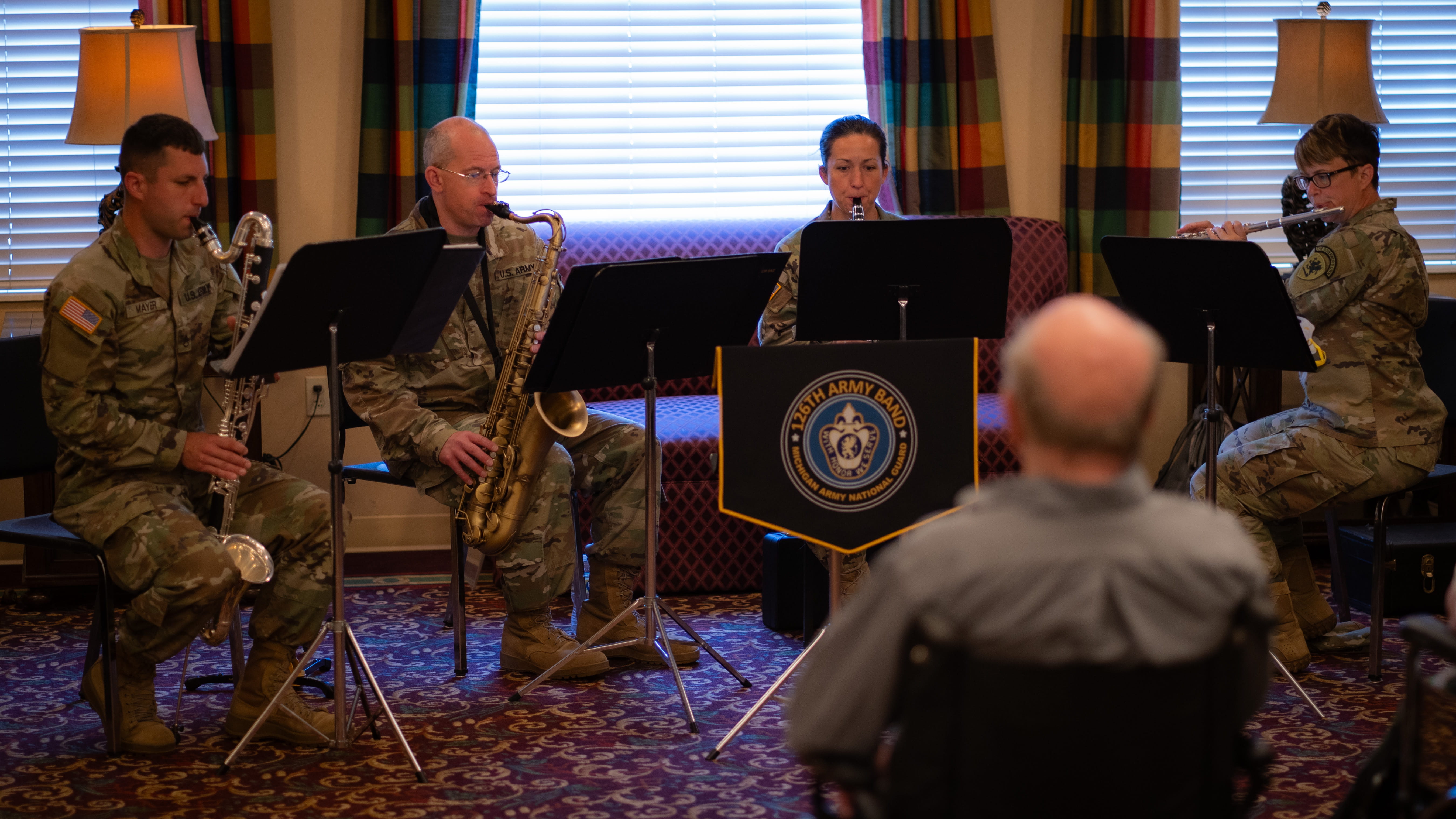service members in uniform seated playing instruments