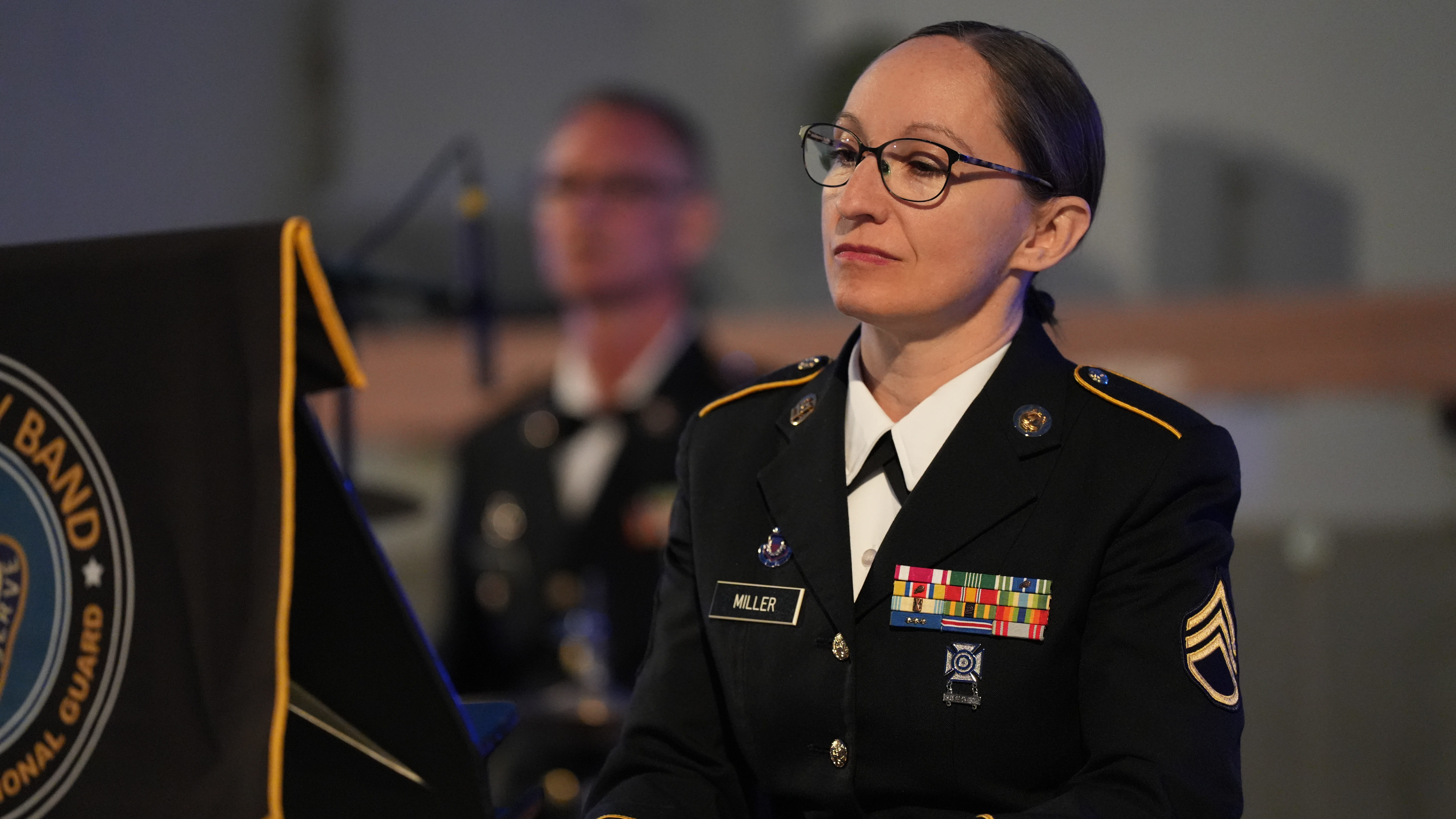 woman service member wearing glasses plays piano