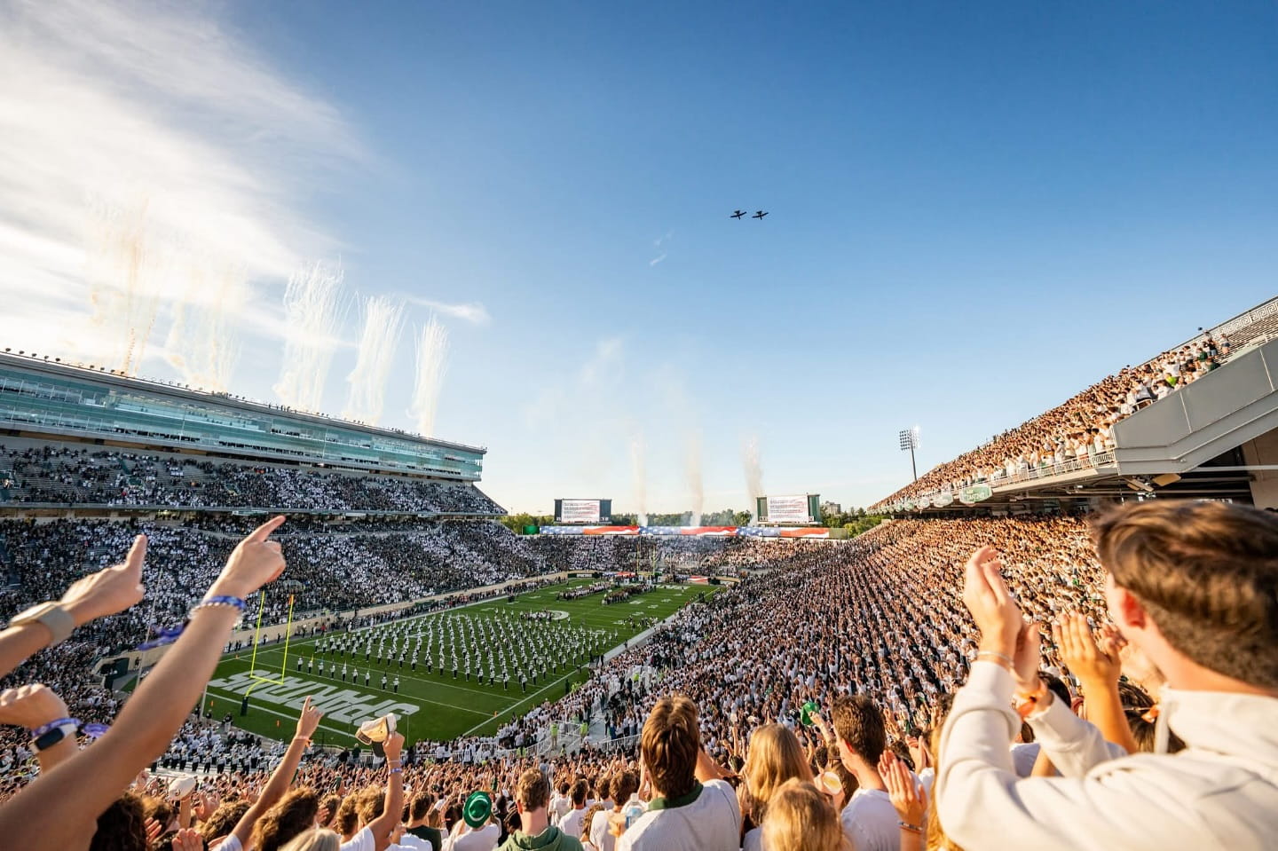 two a-10s flyover Michigan state university football field