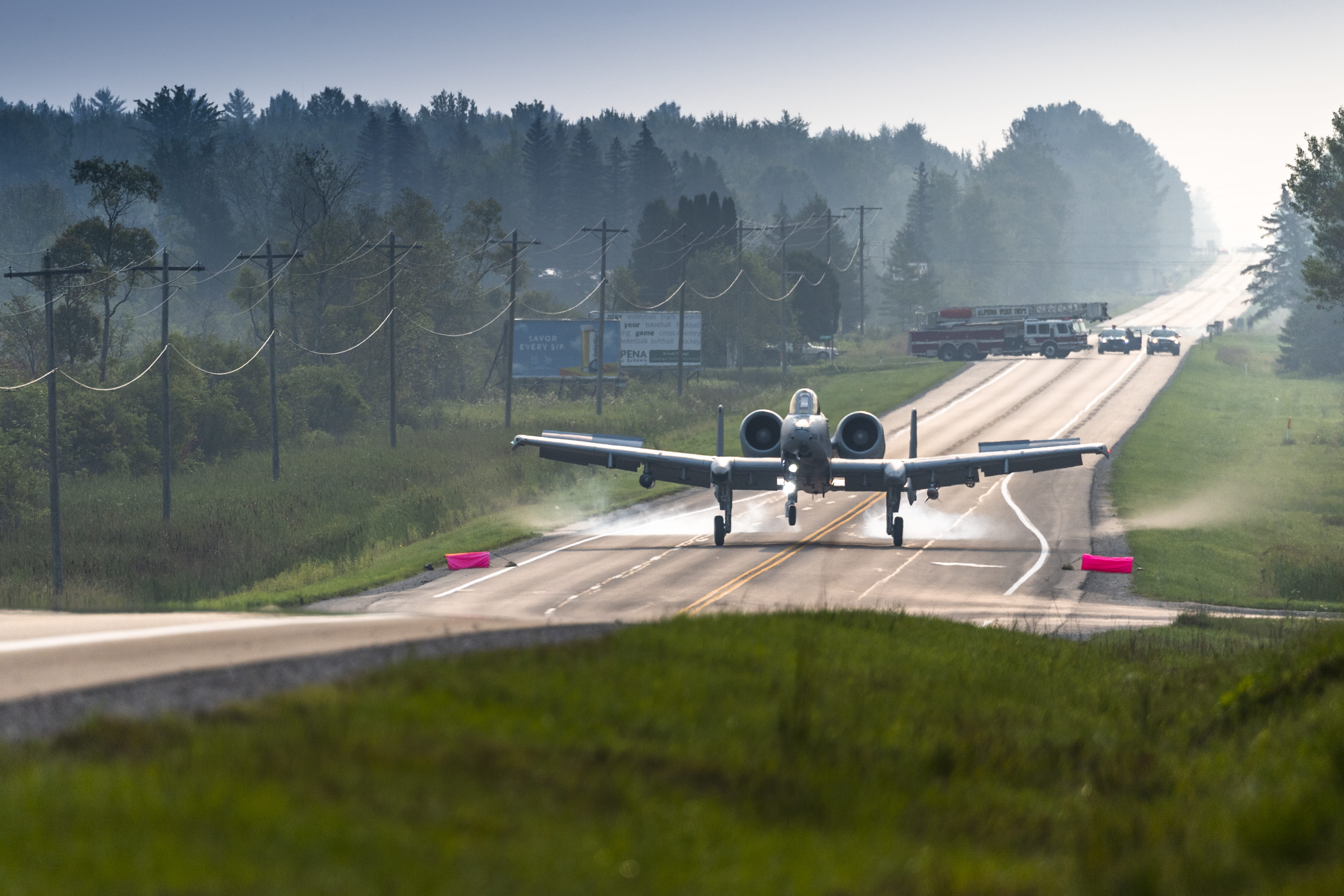 An A-10 Thunderbolt II from Selfridge Air National Guard Base, Michigan prepares to land on a public highway in Alpena, Michigan.