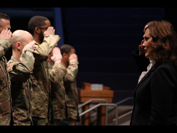 Governor Whitmer salutes Soldiers during a departure ceremony