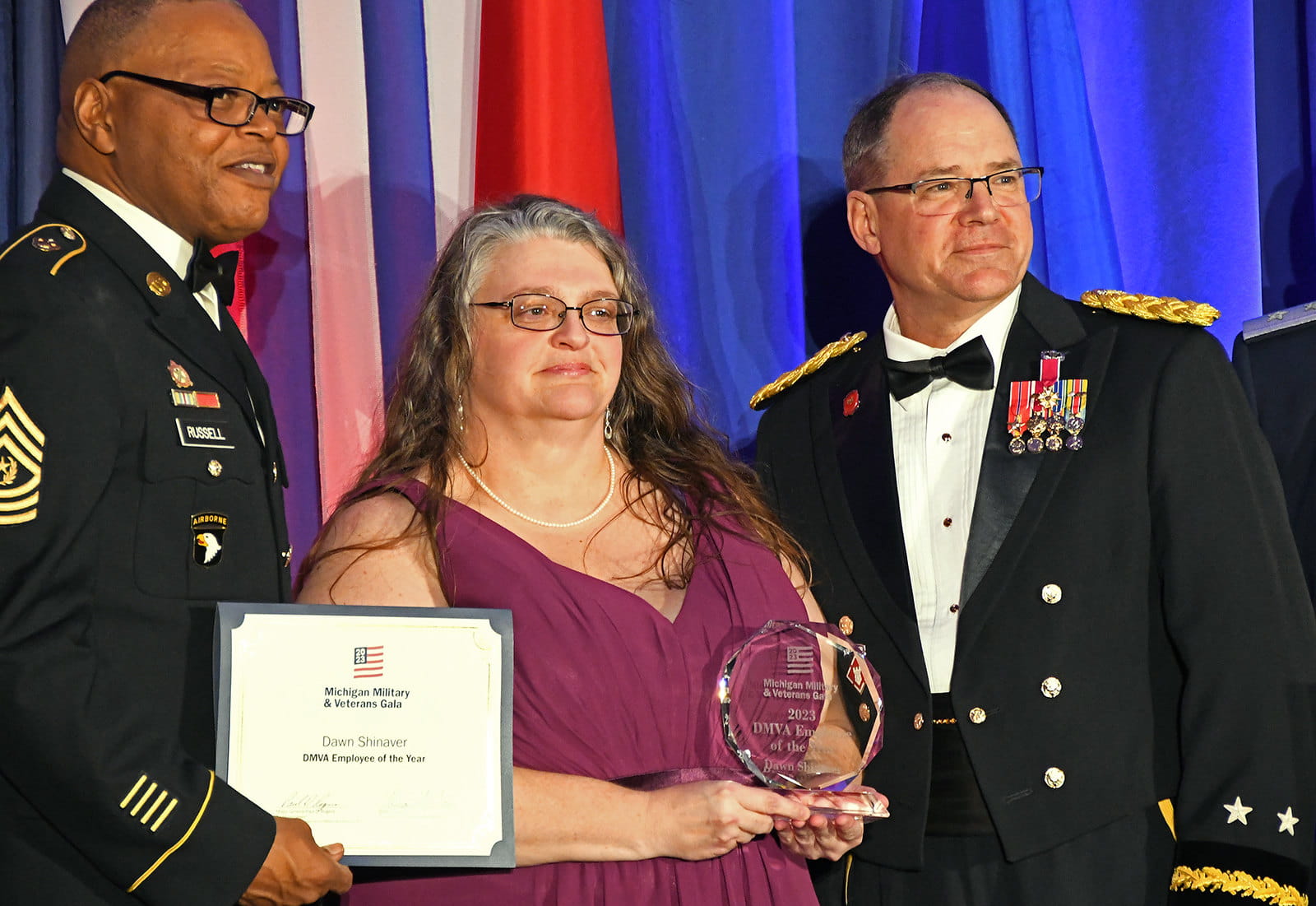 light-skinned men wearing hardhats shoveling dirt at ceremony