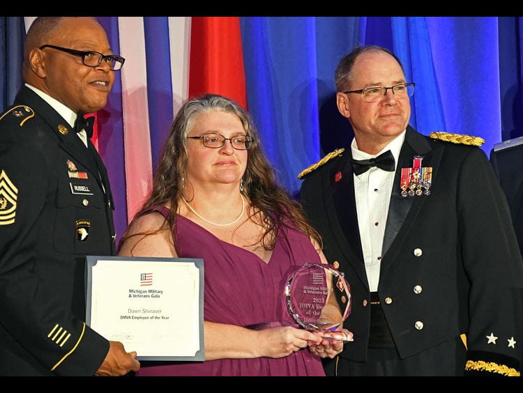 light-skinned men wearing hardhats shoveling dirt at ceremony
