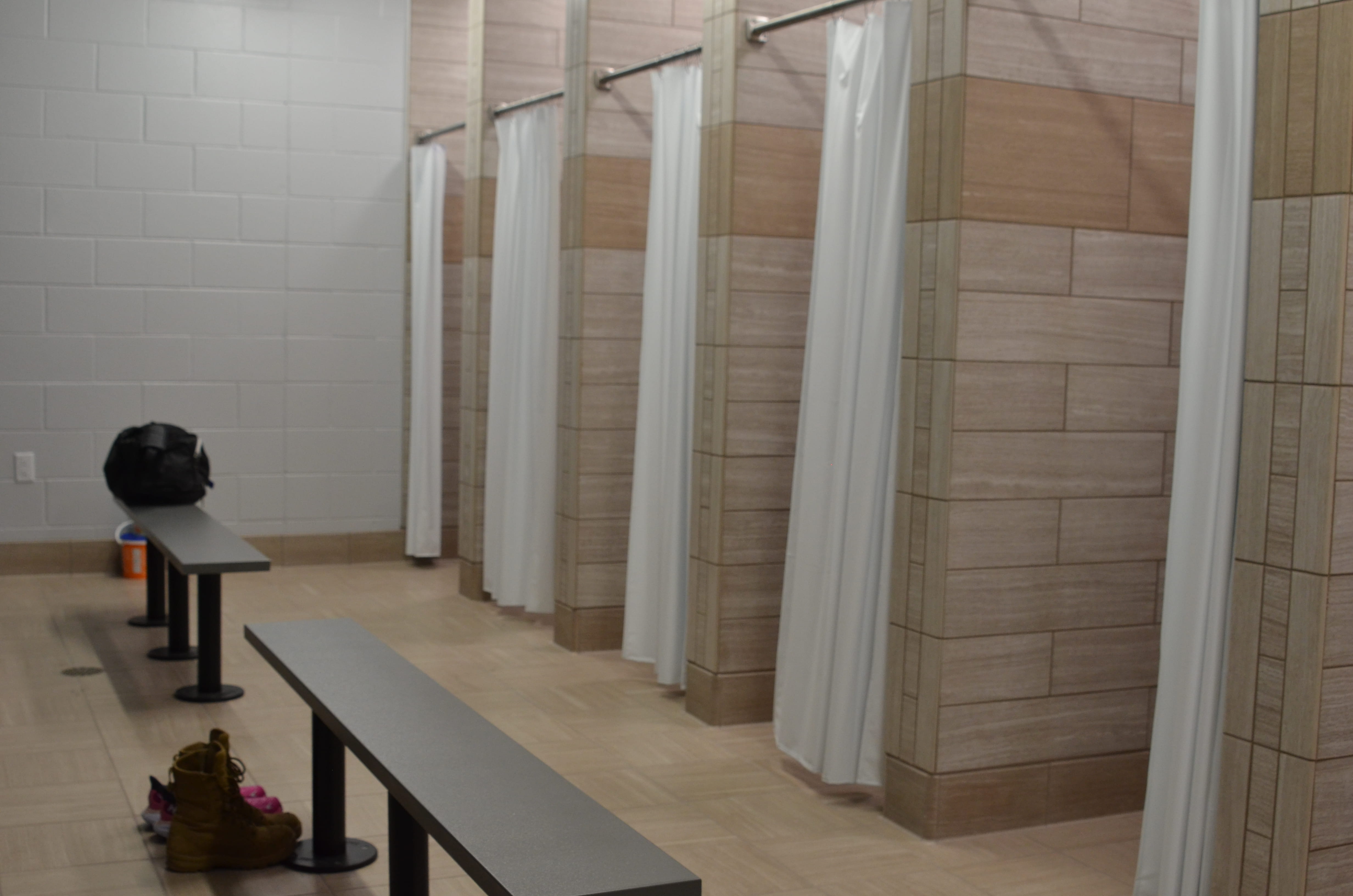 Grand Ledge Armory Womens Showers with bench in foreground