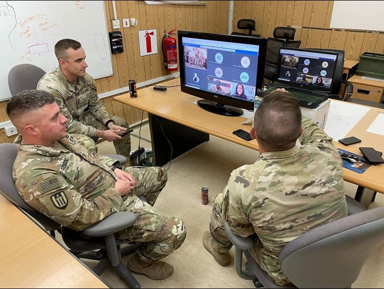Award recipients stand on stage at the gala displaying their certificate