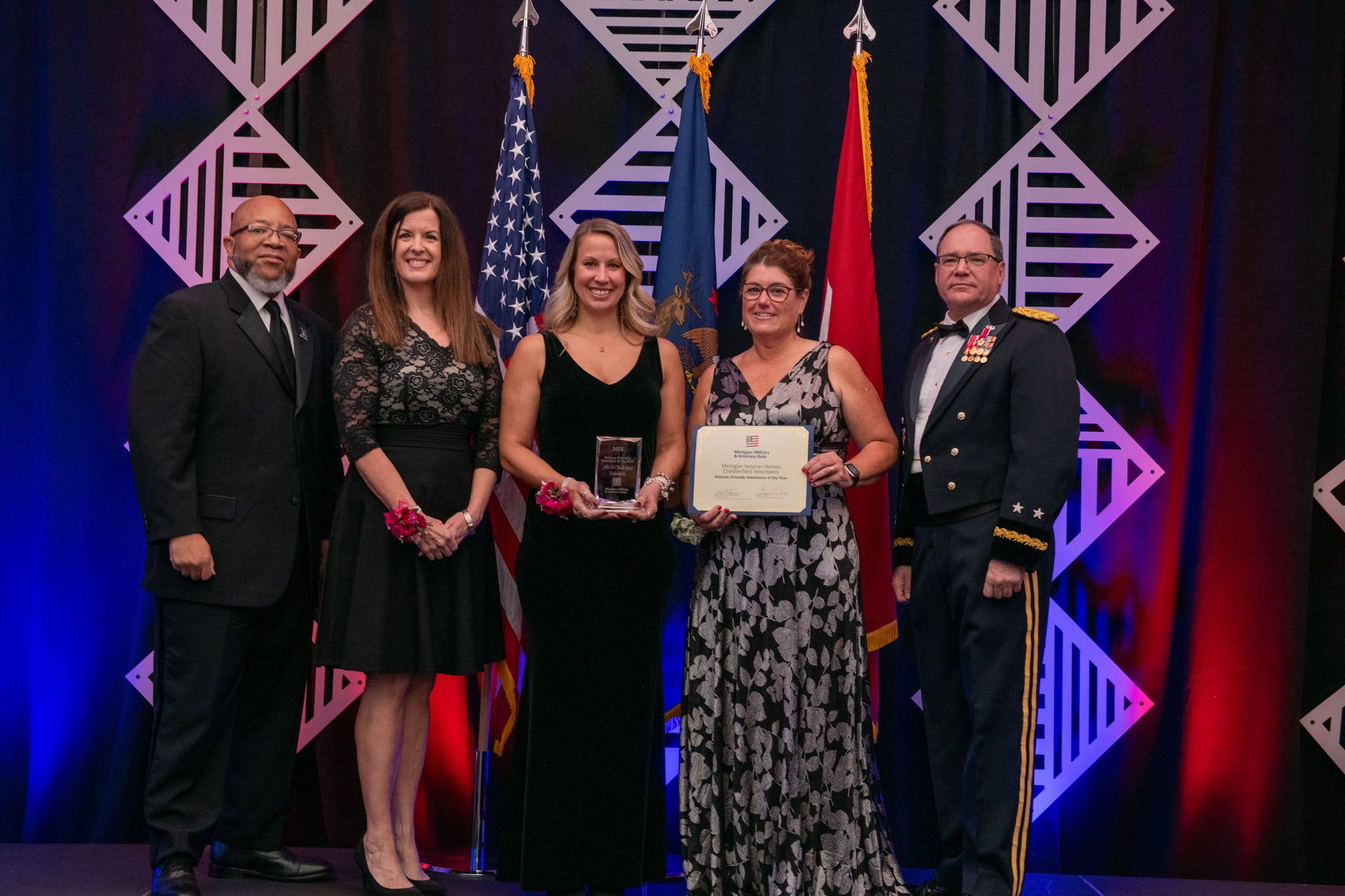 women receive award on stage during gala