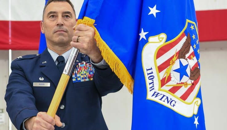 Col. James Rossi present a guidon.