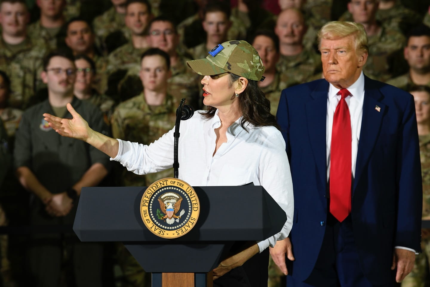governor whitmer addresses troops with president trump standing in background
