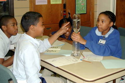 Students study some of the properties of air by using a vortex (tornado)
tube.