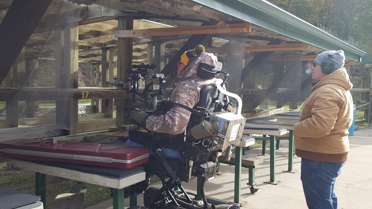 Man in wheelchair at shooting station at DNR Sharonville Shooting Range.
