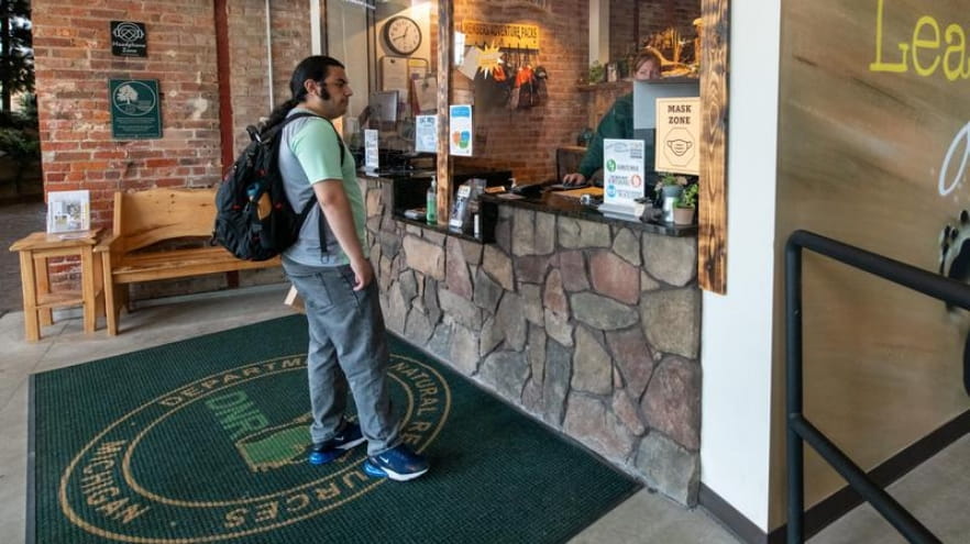 A customer receives assistance at a DNR service center window