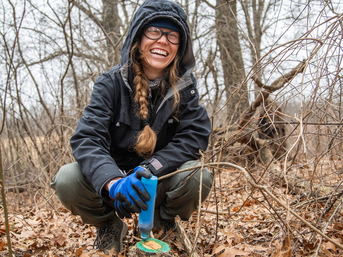 smiling volunteer holding an instrument