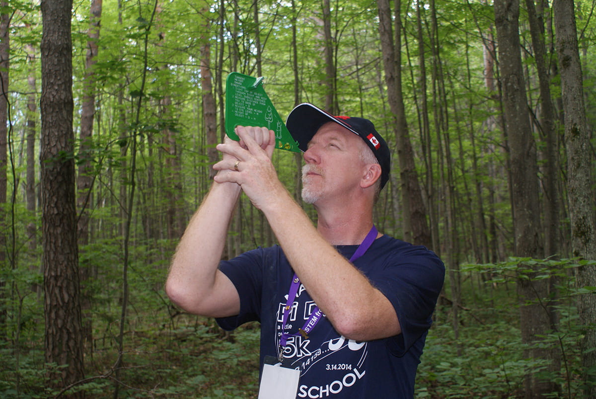teacher measuring tree height