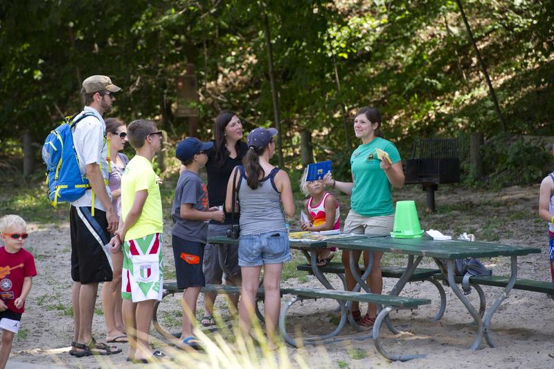 An Explorer Guide leads a group to look for beach glass at Van Buren State Park.