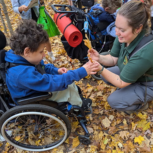 A student in a wheelchair with a DNR educator. 