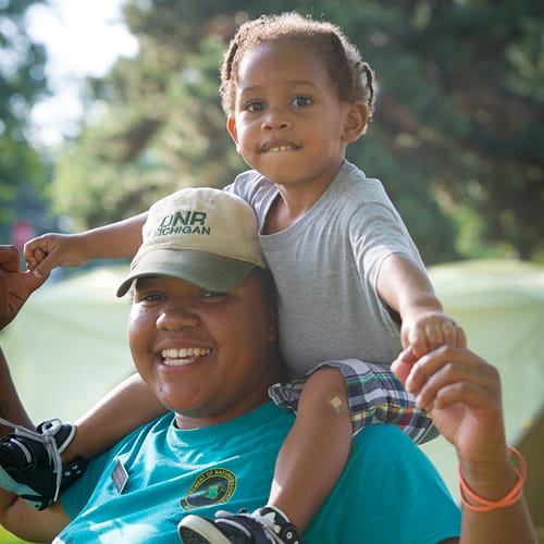 A DNR employee with a young child 