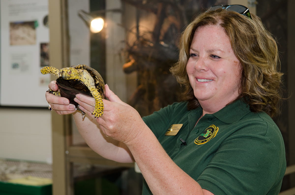 A DNR educator with a turtle.