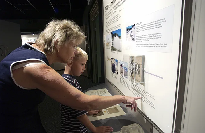 Woman and young boy looking at a nature display