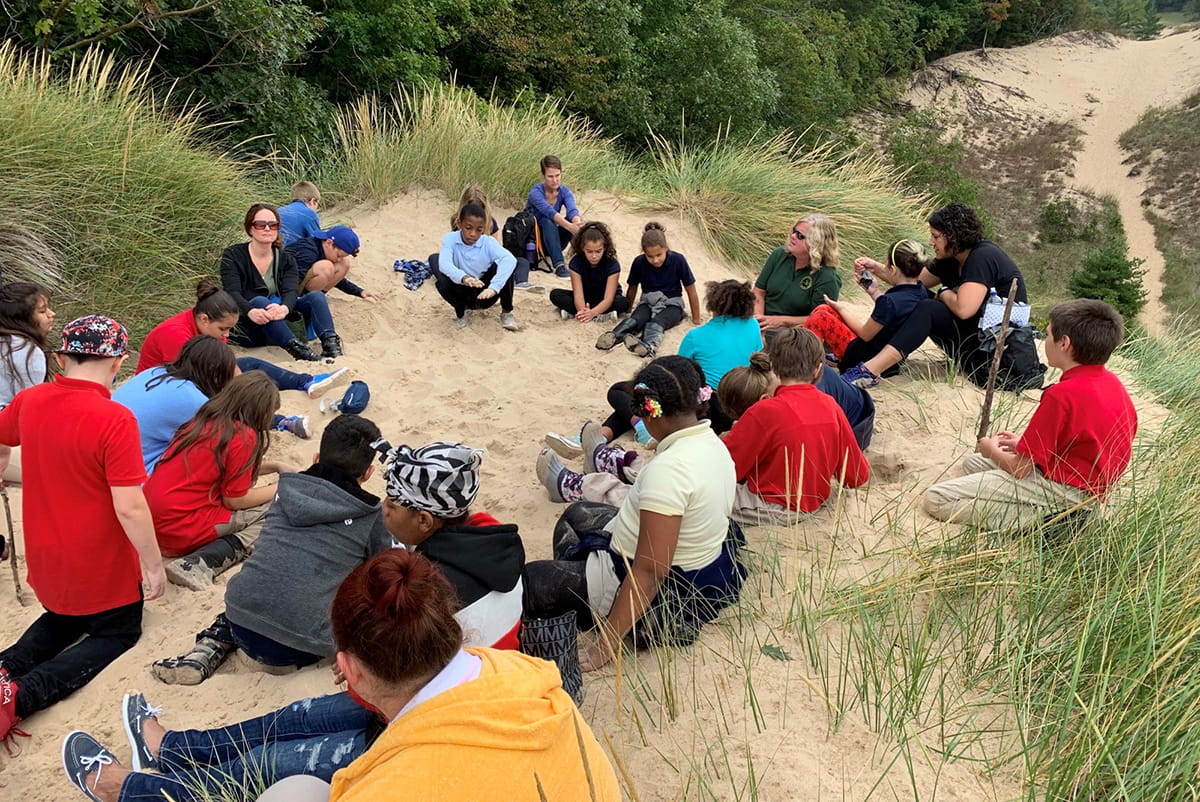 school group learning in the dunes