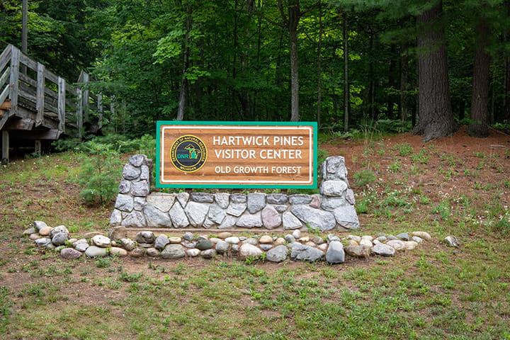 The sign for the Hartwick Pines Visitor Center