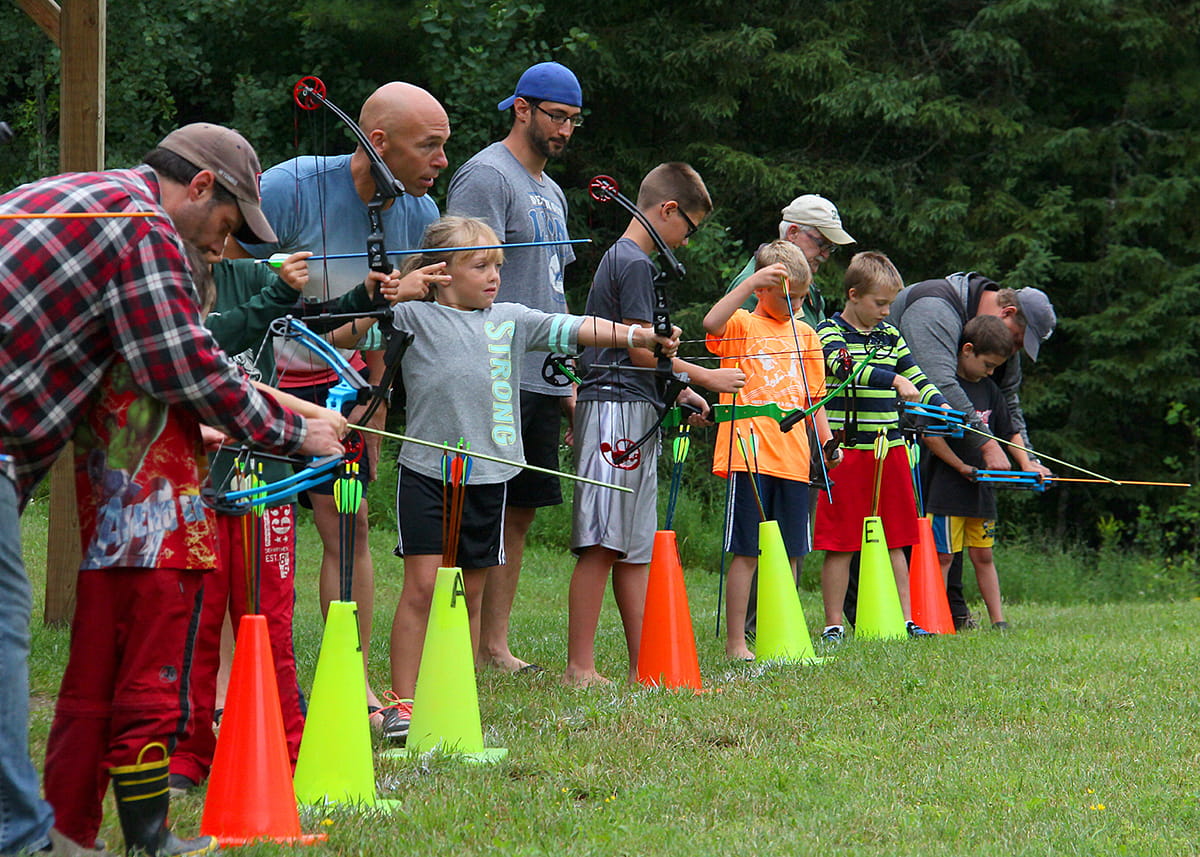 kids and their families learning archery skills