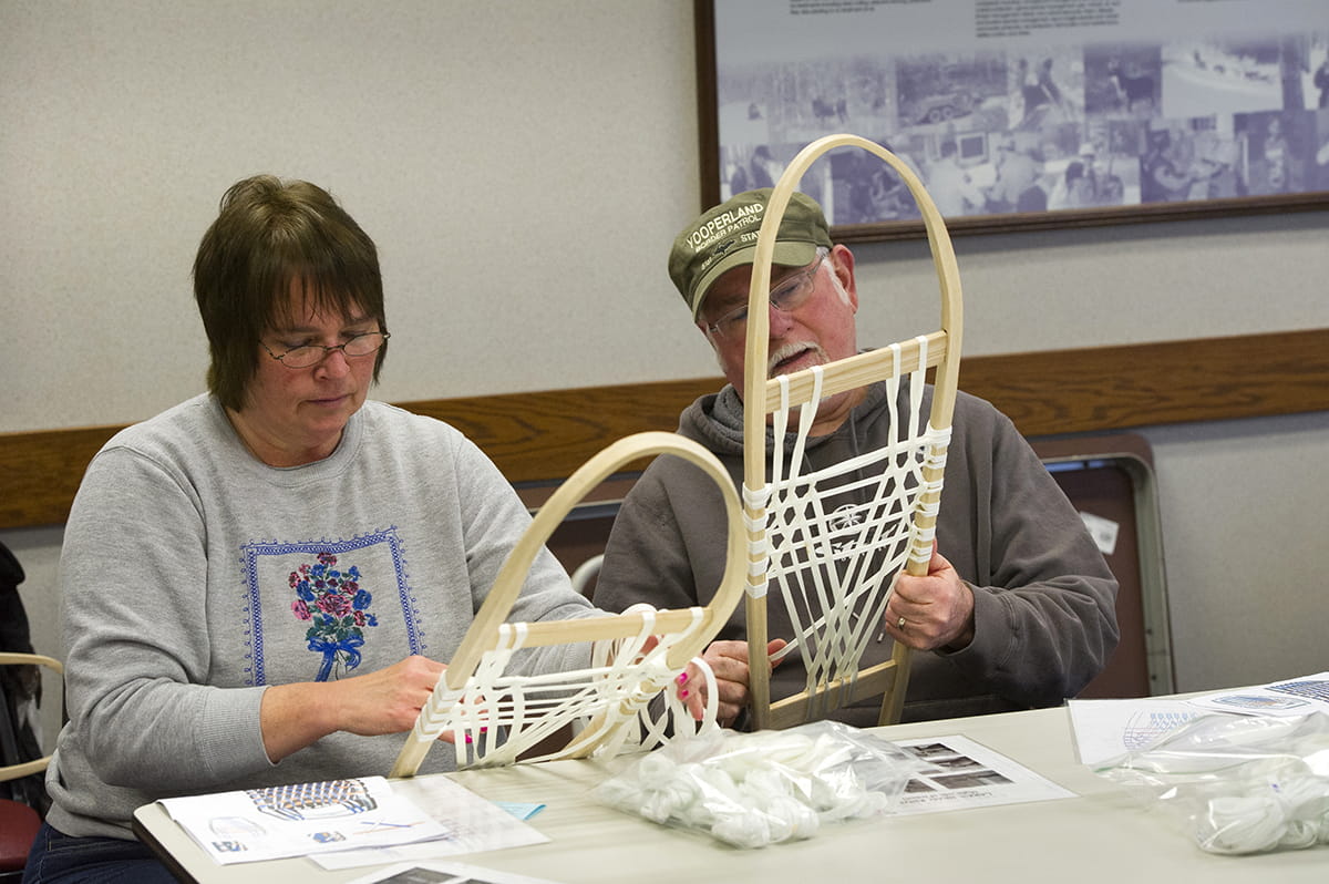 people building snowshoes