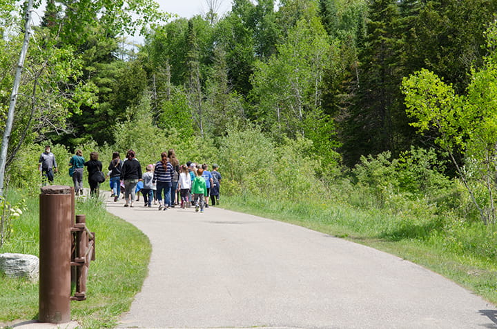 A group walking down a trail at Oden Visitor Center